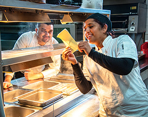 Restaurant workers talking about an order