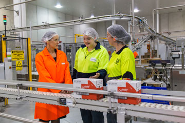 Geraldine Christou visiting a factory.