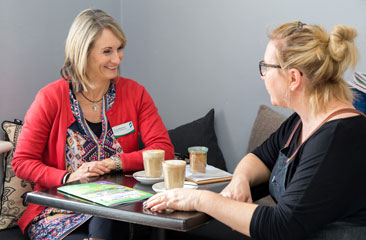 Tricia Martinek meeting with small business owner.